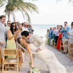 "Destination wedding couple kissing on beach at sunset Riviera Maya Mexico"