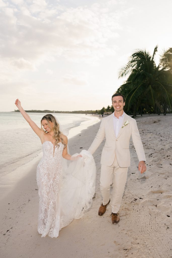 Couple running on the beach after their ceremony Saasil Kantenah Mexico