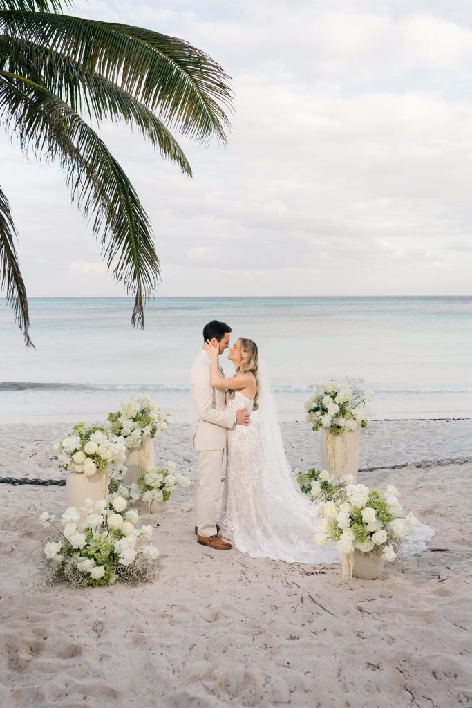 Joyful couple portrait golden light private beach Riviera Maya wedding