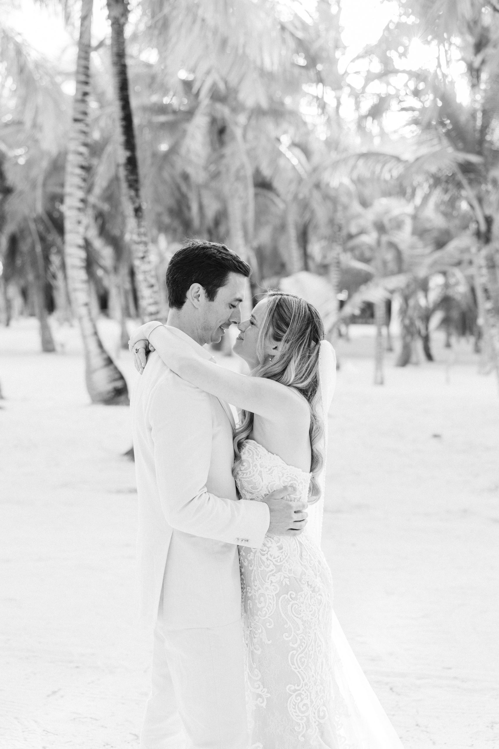 Couple embracing in the ocean after beach ceremony Kantenah Playa del Carmen