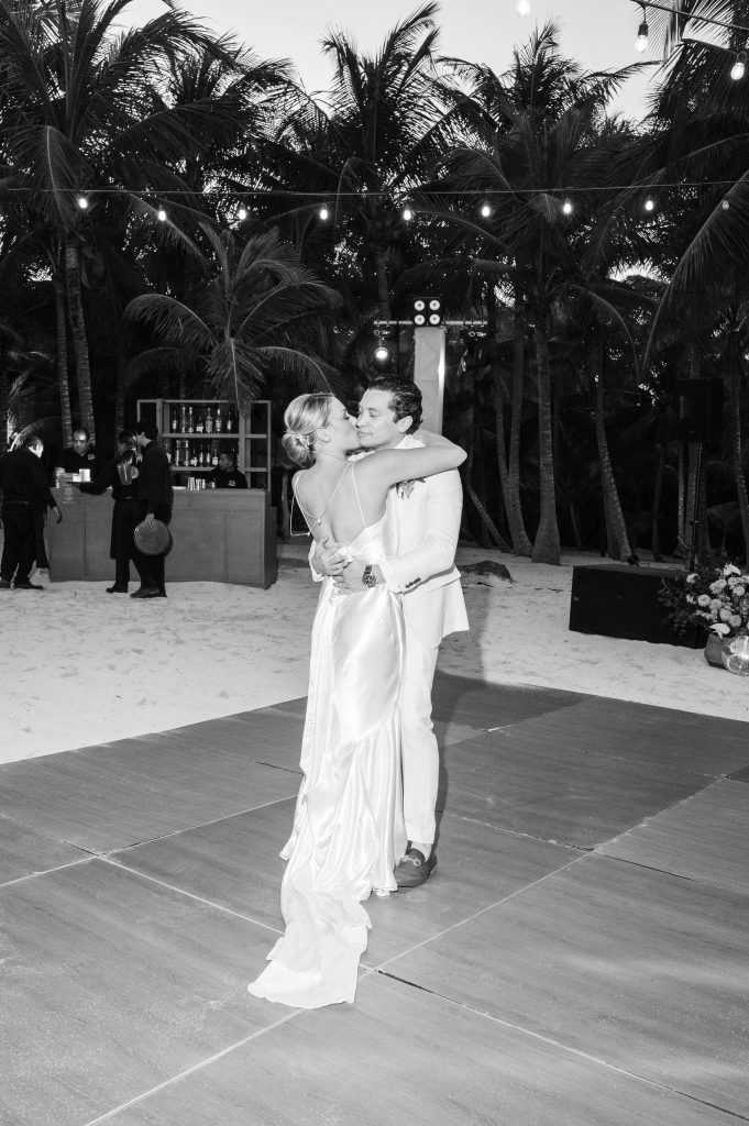 First dance at a Tulum beach wedding as the sun sets, captured by a professional destination wedding photographer in Mexico
