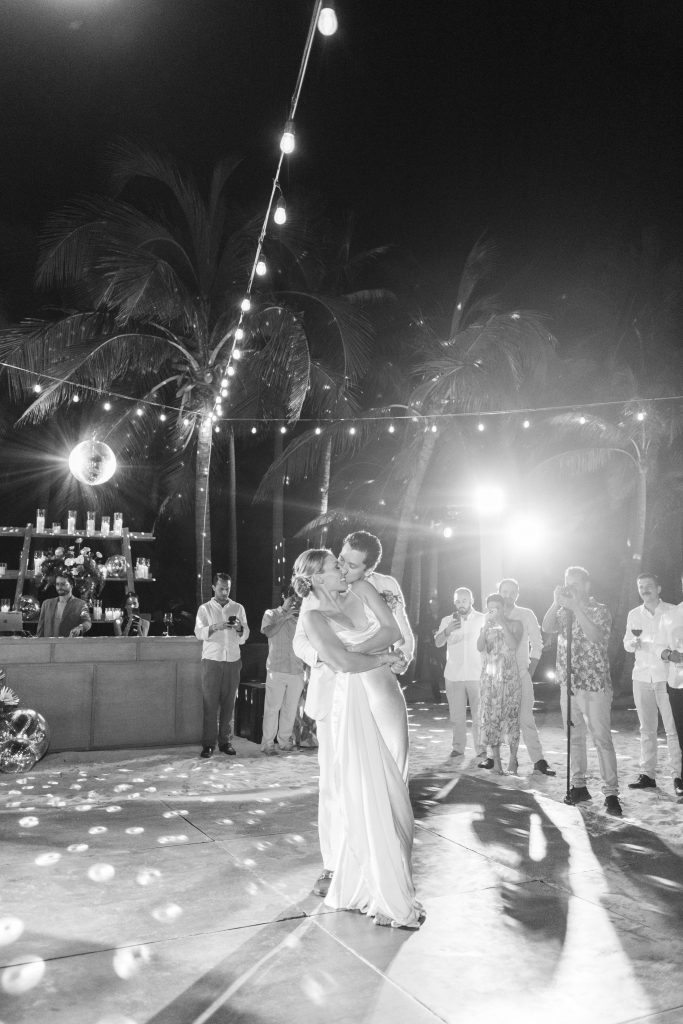 First dance at a Tulum beach wedding as the sun sets, captured by a professional destination wedding photographer in Mexico