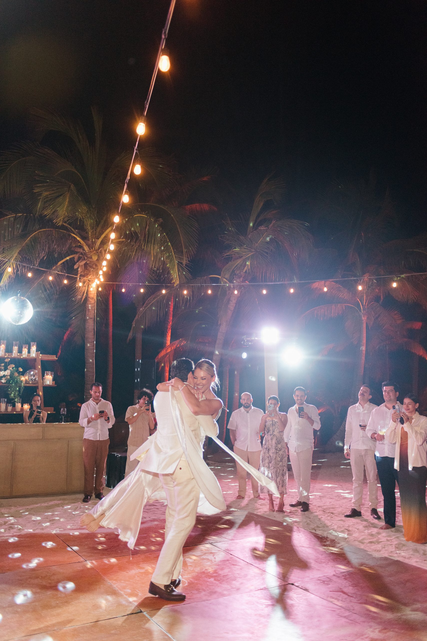 First dance at a Tulum beach wedding as the sun sets, captured by a professional destination wedding photographer in Mexico