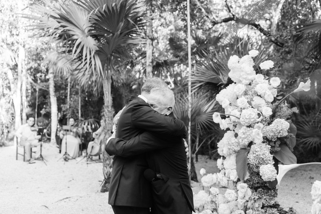 Couple kiss on dance floor at Kima Tulum reception, late night energy