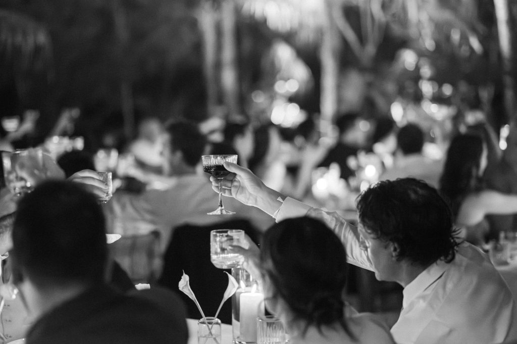 Candlelit dinner reception at Kima Tulum, guests seated under the trees