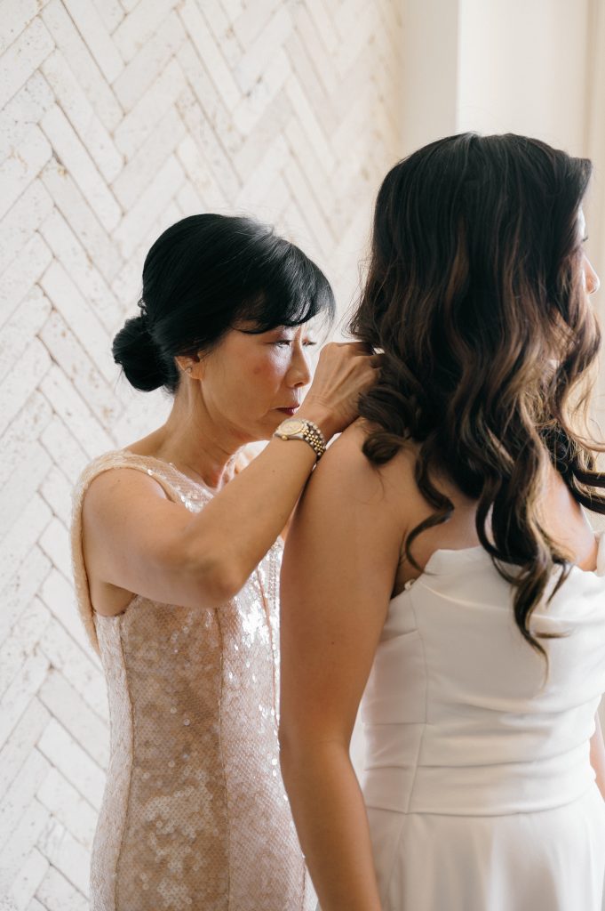 Bridal details on bed, ring and earrings before Kima Tulum ceremony
