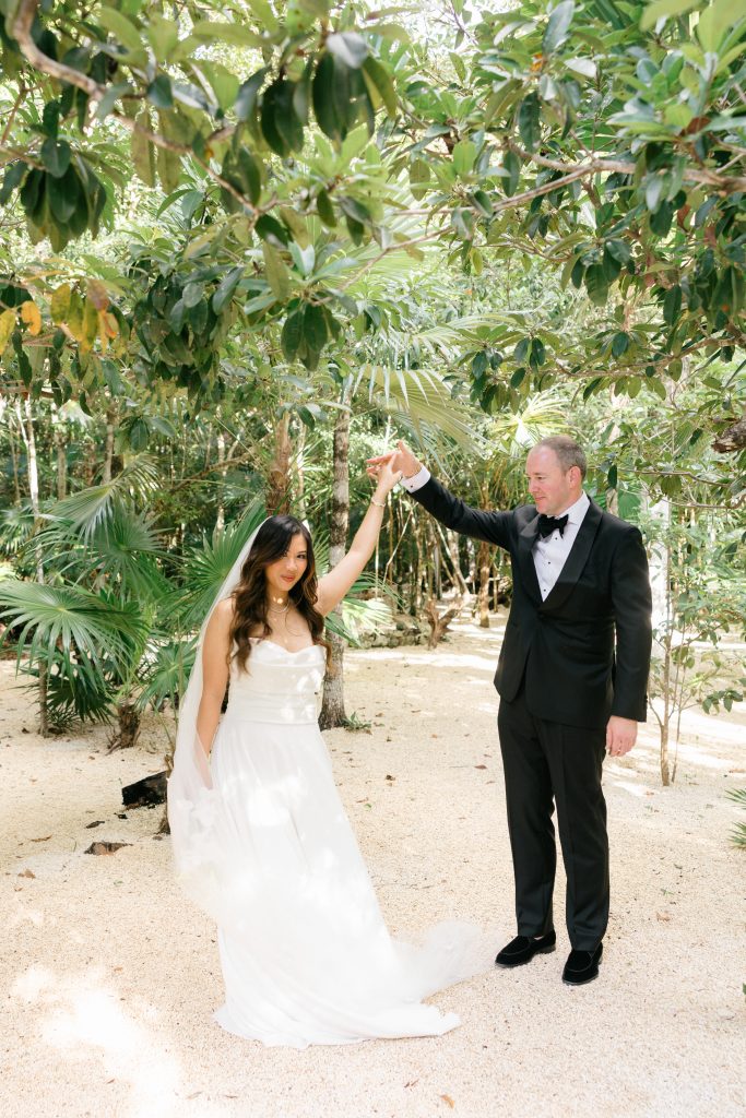 Ceremony detail at Kima Tulum, tropical blooms and palm leaf decor