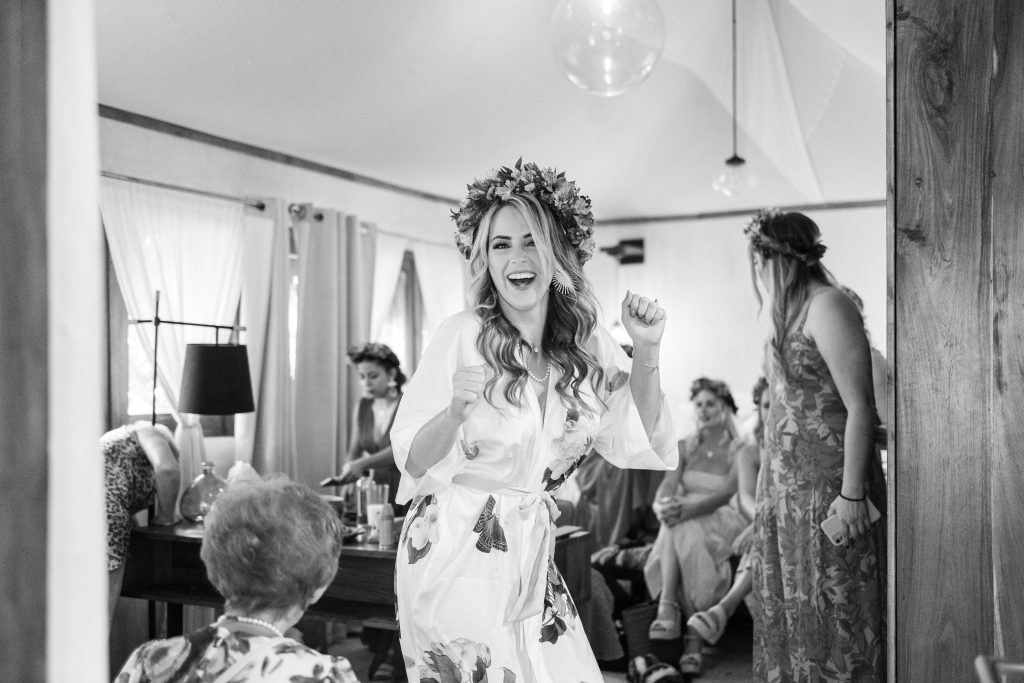 Bride laughing in the gardens of Espacio Chechén on her wedding day in Tulum