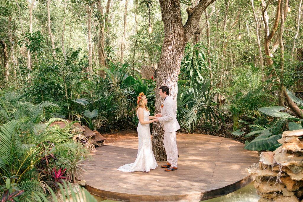 wedding at Espacio Chechén, bride and groom dancing on the circular wooden deck surrounded by jungle