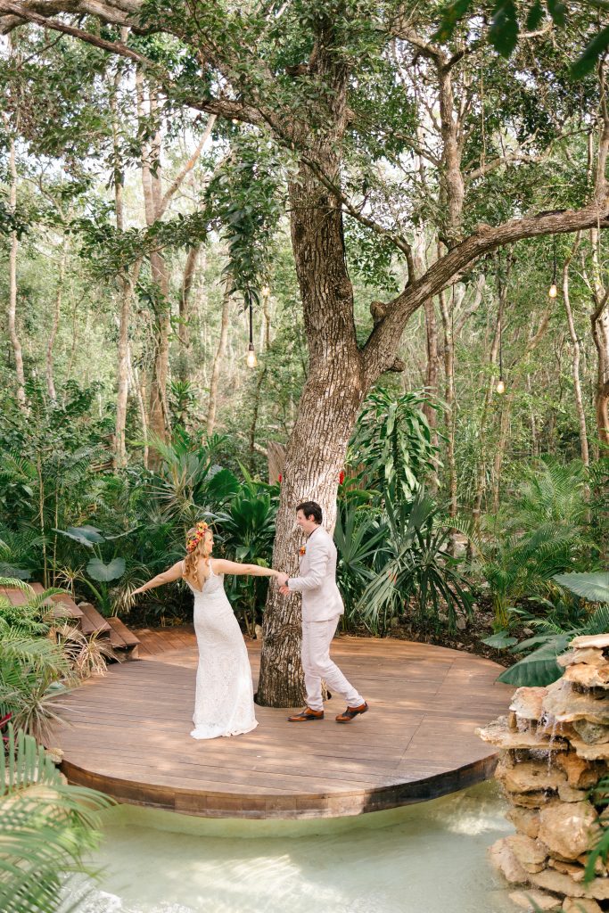 Wedding at Espacio Chechén, bride and groom dancing on the circular wooden deck surrounded by jungle
