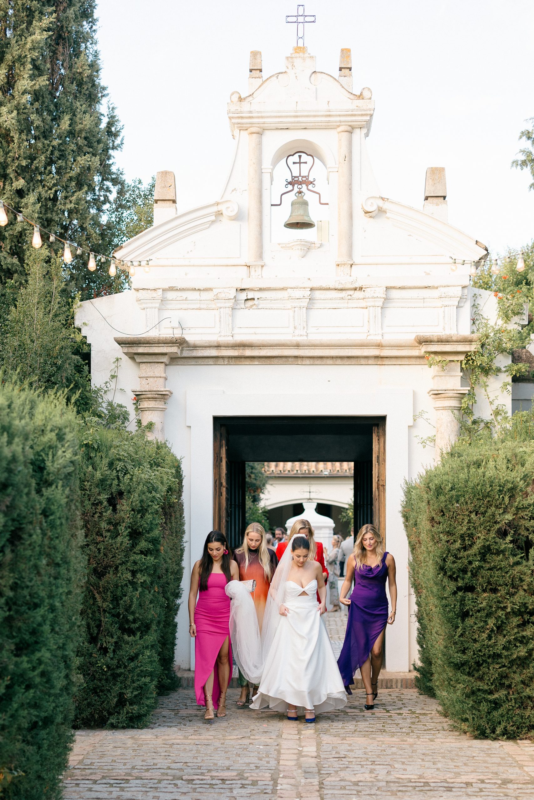 The bride's team walking through a garden in Portugal.