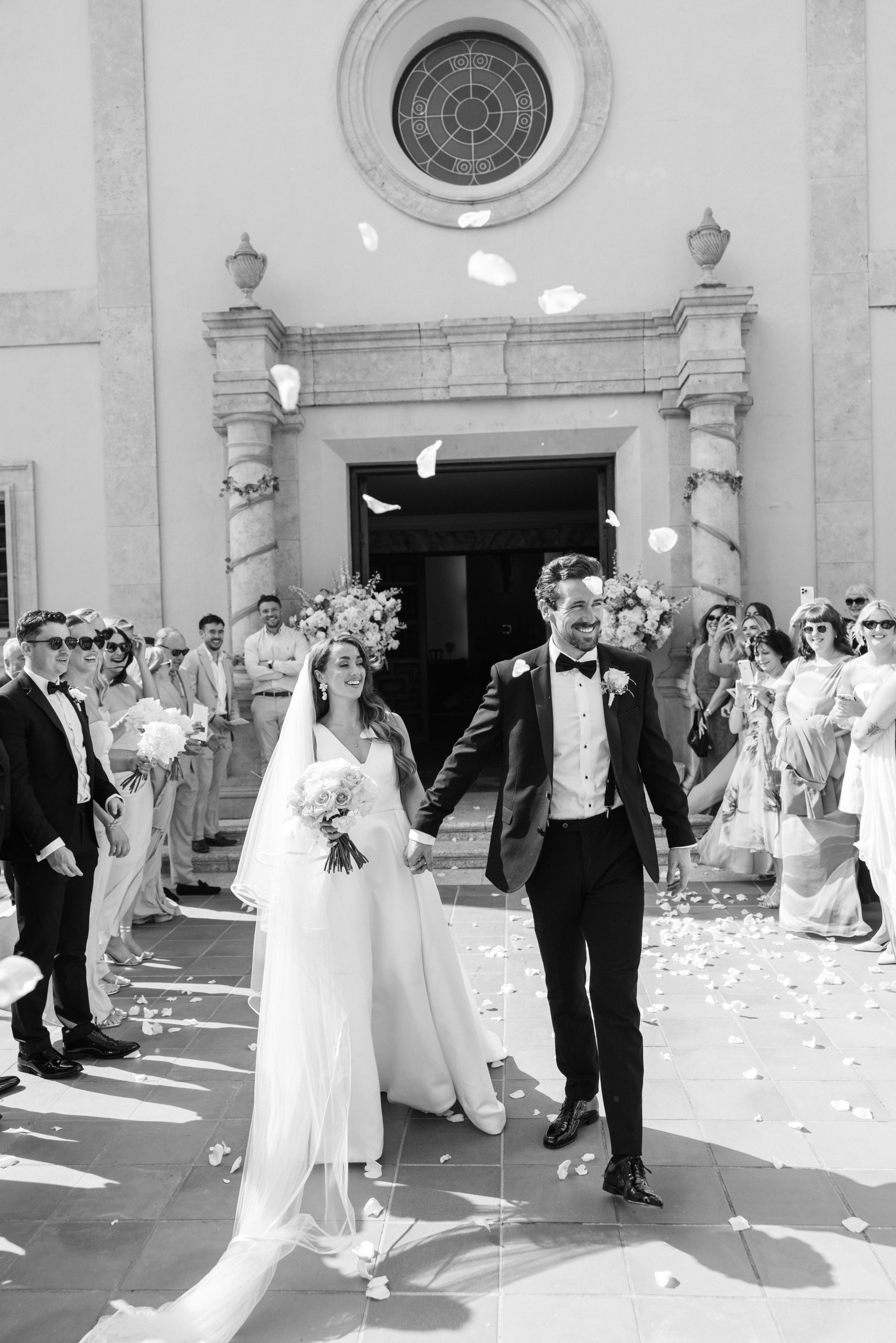 a newlywed couple leaving a Portuguese church