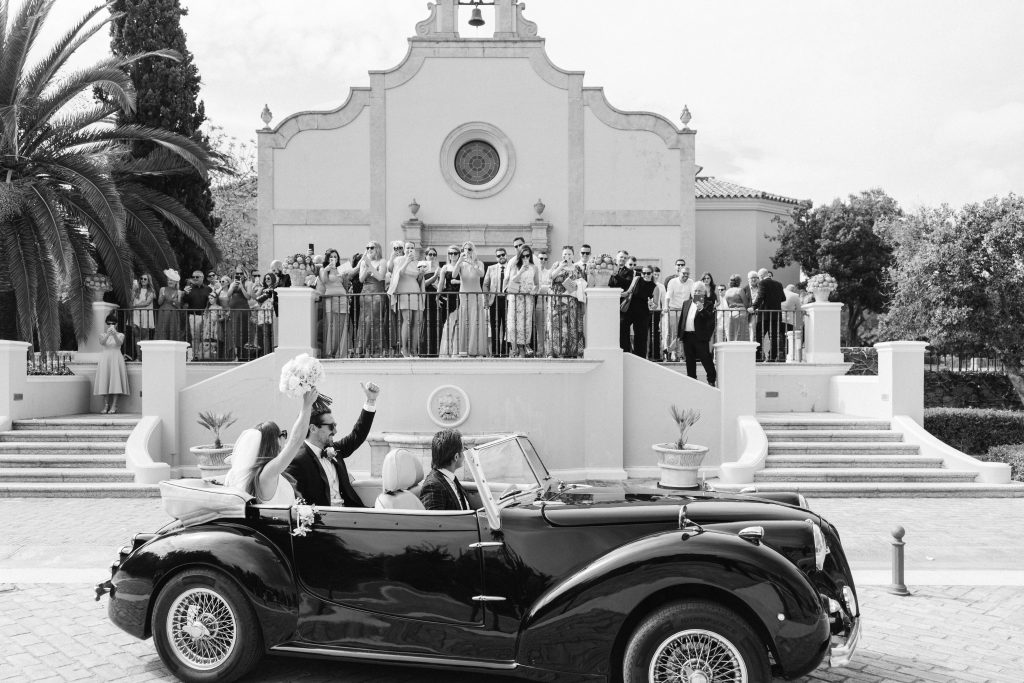 a couple after yes, i do! in a car betwen their guests in Lisbon, Portugal